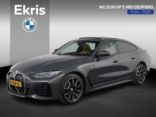 BMW i4 eDrive40 High Executive 84 kWh Dravitgrau met Cognac Volleder | M Sport | Elektrisch Schuif-/kanteldak | M Stoelen Elektrisch | Harman Kardon | Laserlight | Camera | Comfort Access