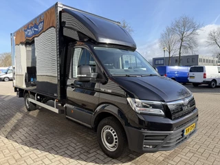 Hoofdafbeelding MAN TGE MAN TGE 35 2.0 Lang L4 Super Hoog 177pk bakwagen met Dhollandia laadklep / euro 6 / bpm vrij / vaste prijs rijklaar € 38.950 ex btw / lease vanaf € 636 / zwart metallic