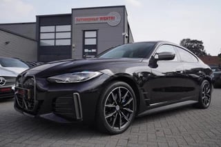 Hoofdafbeelding BMW i4 BMW I4 M50 High Executive 84 kWh|Schuifdak|H&K|Carbon|Head Up