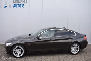 Hoofdafbeelding BMW 4 Serie BMW 420i Gran Coupé Luxury Jatoba Schuifdak HUD 360° Camera HiFi Keyless M-Stuurwiel Zeer mooi!